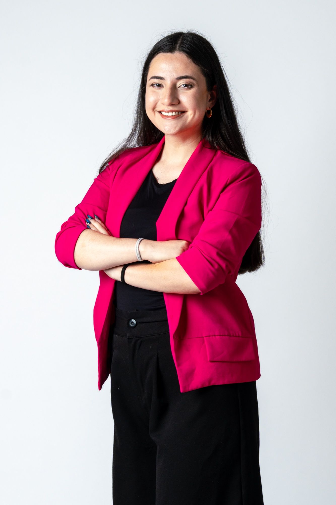 Retrato de Angie Paladines, psicóloga clínica, con los brazos cruzados y una sonrisa